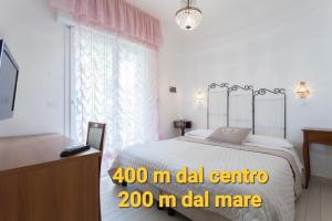 A bed or beds in a room at B&B Airone Cervia - Camere e Appartamenti