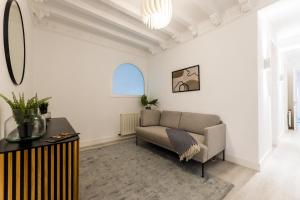 a living room with a couch and a window at BALEA Suite apartment in San Sebastián
