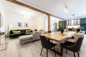 a living room with a wooden table and chairs at BALEA Suite apartment in San Sebastián