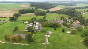 an aerial view of a mansion in a green field at Bungalowpark Landsrade in Gulpen