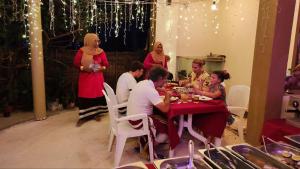 a group of people sitting at a table eating at Kokaa Villaa Maaenboodhoo - The speedboat from Malé to the hotel departs at 1130 every Monday Thursday and Saturday and from the hotel to Malé at 0630 and five domestic flights are available every day in Dhaalu Atoll