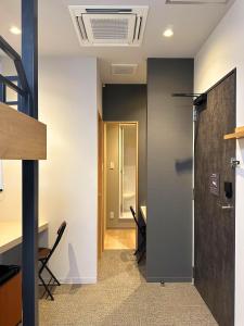 an office with a door and a desk and chairs at COB HOTEL Asakusa in Tokyo