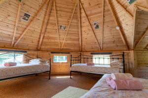 een kamer met 3 bedden in een houten hut bij Dartmoor Lodge (Oak Tree Lane) in Okehampton