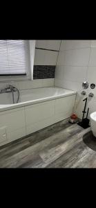 a bathroom with a bath tub and a sink at Casa qui Piccola Eifel in Hellenthal