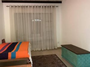 a bedroom with a bed and a window at Mind Body and Soul in Dambulla