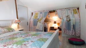 a bedroom with a large bed with a canopy at Gite La Pipistrelle 