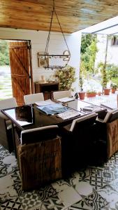 a dining room with a table and chairs and a door at Gite La Pipistrelle 