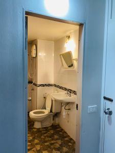 a bathroom with a toilet and a sink at Condo popular T8 Fl.5 in Thung Si Kan