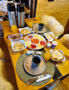 a table topped with plates of breakfast foods and drinks at Parador dos Canyons in Cambara do Sul