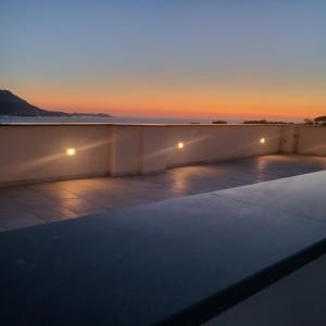 a view of the sunset from the roof of a building at Palazzo Palumbo in Procida