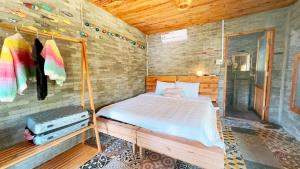 a bedroom with a bed in a wooden room at Me Bungalow Beach Resort in Phan Thiet
