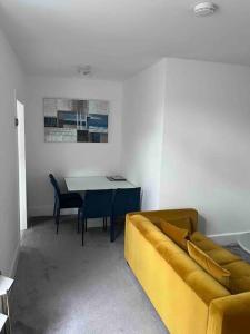 a living room with a couch and a table at The Mews, private parking included, Windermere in Windermere