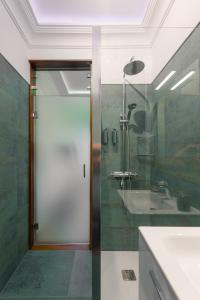 a bathroom with a shower and a glass door at Mini Suite 35 qm in Valle Gran Rey
