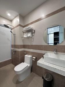 a bathroom with a toilet and a sink and a mirror at Ana's House in Quy Nhon