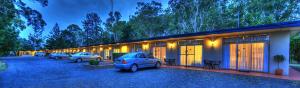 a group of cars parked outside of a building at All Seasons Country Lodge in Taree