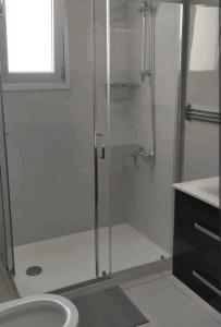 ein Bad mit einer Dusche und einem Waschbecken in der Unterkunft Nice flat in Tseri