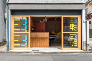 a glass door of a building with a table inside at 三津ミーツ in Mitsuhama