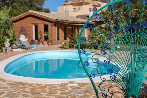 a swimming pool in front of a house at Finca verde de la luz in Barbate