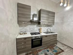 una cucina con lavandino e piano cottura forno superiore di NEWHOUSE ANTIUM ad Anzio