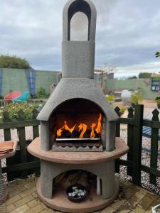 a stone oven with a fire inside of it at Nautical South Self-contained Dog Friendly Annexe in Fareham