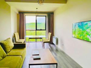a living room with a couch and a table at Kechi House Retreat in Tsaghkadzor in Tsaghkadzor