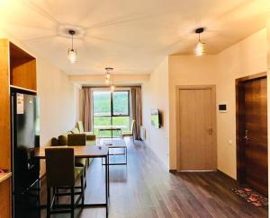 a dining room and living room with a table and chairs at Kechi House Retreat in Tsaghkadzor in Tsaghkadzor