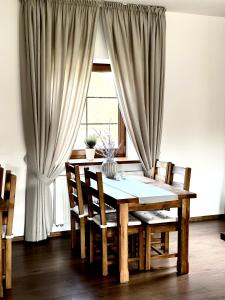 a dining room table and chairs in front of a window at Harmony Park 