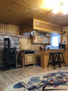 a kitchen with a stove and a stove top oven at Inchirieri cabana- “Chalet Rustique” in Covasna