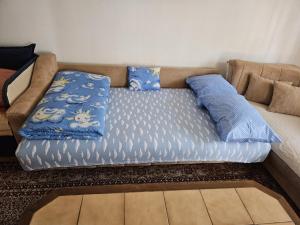 un sofá con almohadas en una habitación en SARAJEVO APARTMENT, en Sarajevo