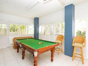 a room with a pool table and two chairs at Noosa Dua Apartment 2, Noosaville in Noosa Heads