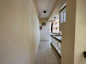 a hallway of a store with a long aisle at Hotel Leela Inn Candolim in Marmagao