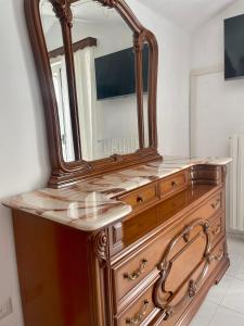 a wooden dresser with a mirror on top of it at Vico Gioia in Roccasicura