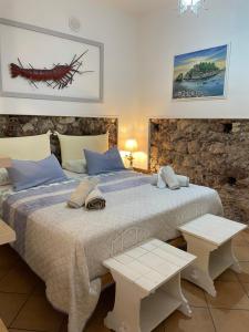 a bedroom with a large bed with two tables at Salu’ in Taormina