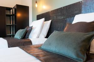 Habitación de hotel con 2 camas y almohadas en Domaine La Grange Ungersheim - Chambres d'Hôtes L'Inspiration en Ungersheim