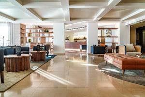 a lobby of a hotel with tables and chairs at Hotel Dom Goncalo & Spa in Fátima