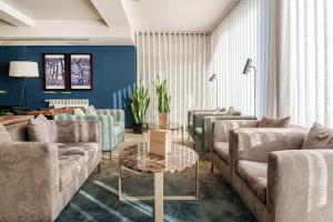 a living room with couches and a table at Hotel Dom Goncalo & Spa in Fátima