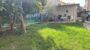 a yard with a tree and a table in it at Bonsai - Bed & Breakfast in Pesaro