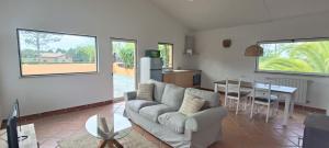 a living room with a couch and a table at Casas da Barra in Praia de Mira