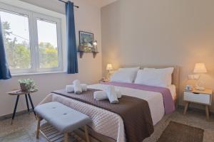 a bedroom with a bed with two towels on it at Vivid Stays Petralona in Athens