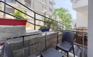 two chairs sitting on the balcony of a building at eYLÜL 16 OTEL in Çeşme