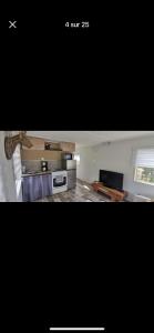 een foto van een keuken en een woonkamer bij Mobile home N 48 sur camping 4 étoiles in Fourmies