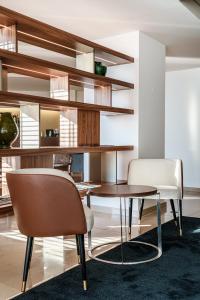 a dining room with a table and two chairs at Hotel Dom Goncalo & Spa in Fátima