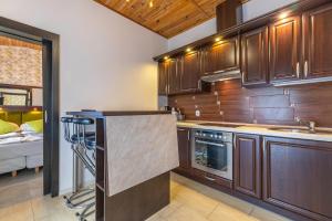 a kitchen with wooden cabinets and a counter top at Apartamenty Amber in Rewal