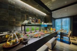 a buffet line with food on a table in a restaurant at Hotel Westend in Nuremberg