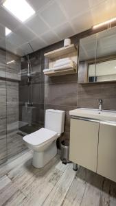 a bathroom with a toilet and a sink and a shower at eYLÜL 16 OTEL in Çeşme