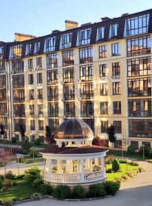a large building with a gazebo in front of it at Apartments Club Marine in Odesa