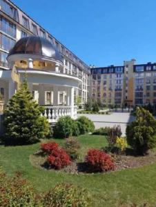 a large building with a dome on top of it at Apartments Club Marine in Odesa