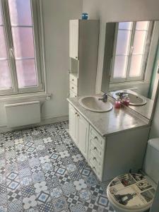 a bathroom with two sinks and a mirror at La plage in Fécamp
