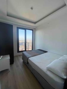 a bedroom with a large bed and a large window at Luxurious 3-Bedroom Apartment with Panoramic Views in Istanbul