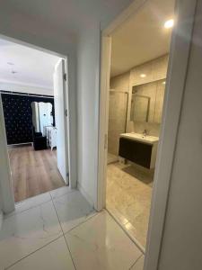 a view of a bathroom with a sink and a mirror at Luxurious 3-Bedroom Apartment with Panoramic Views in Istanbul